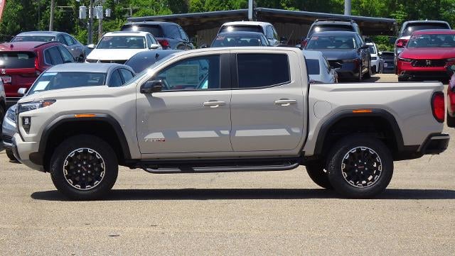 2026 GMC Canyon AT4 in Coastal Dune — front three-quarter view